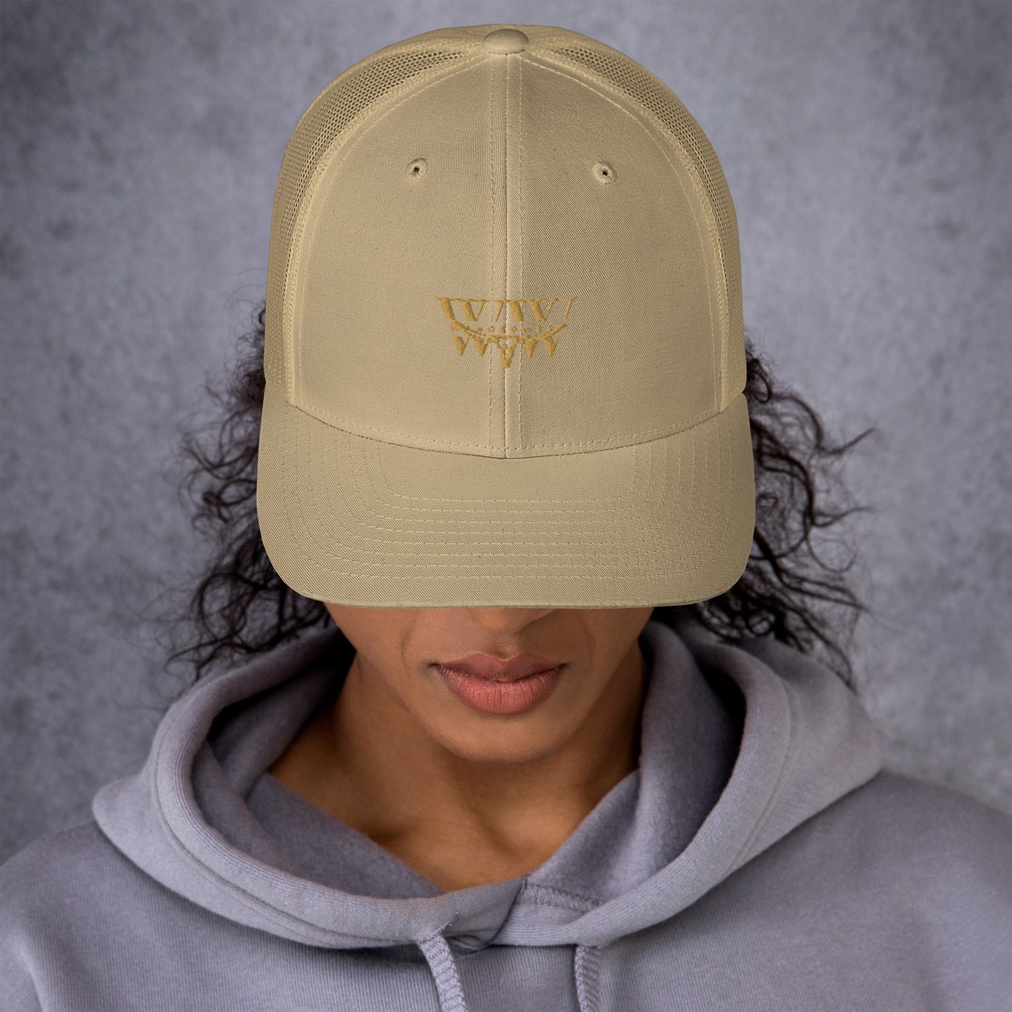 Beige WanderWest Logo Trucker Cap with mesh back and structured design.