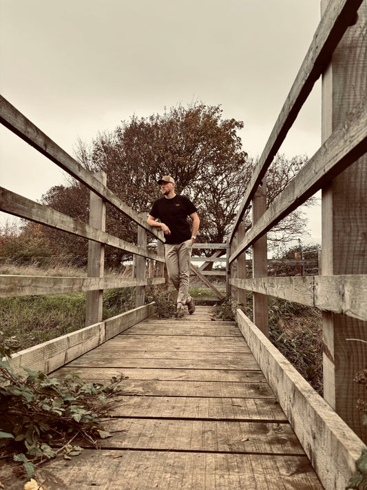 The WanderWest Midnight Rider Tee for a bold, versatile black shirt with embroidered logo, perfect for casual country or streetwear looks. Style and comfort.