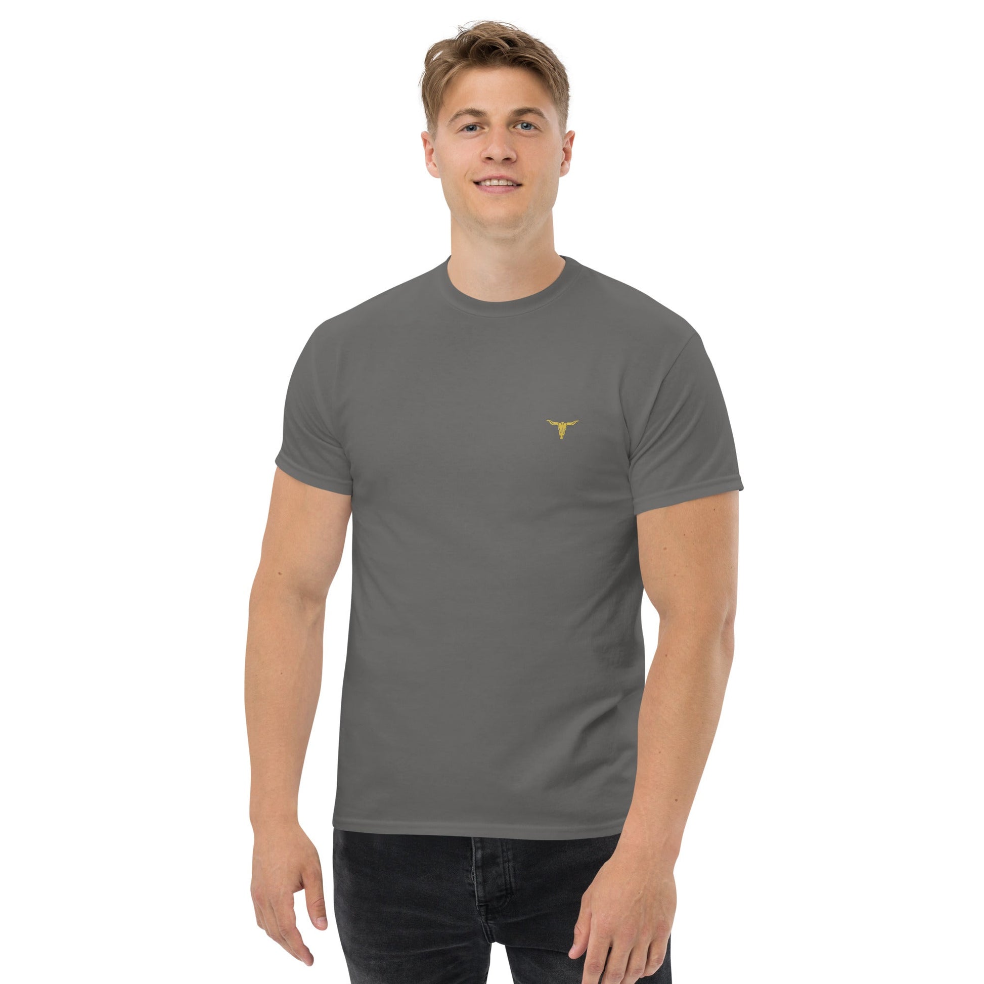 Man wearing a gray Bull Horn unisex classic tee with a small yellow bull horn logo on the chest, styled with black jeans.
