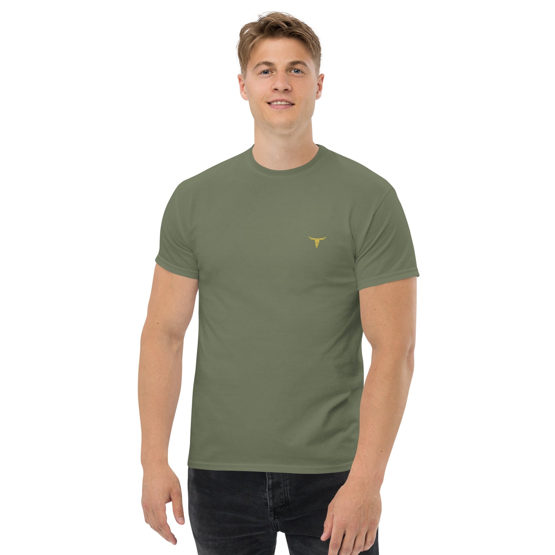 Man wearing olive green Bull Horn unisex classic cotton tee with small yellow bull horn logo on front left chest.