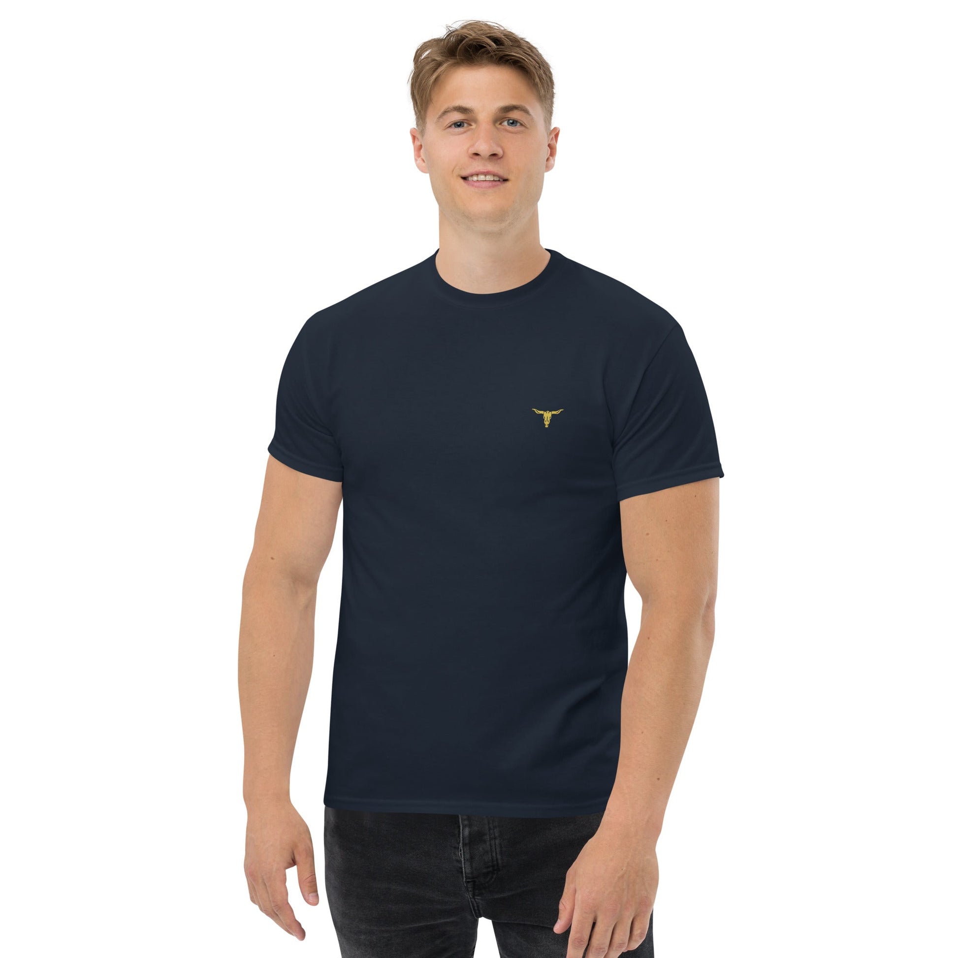 Man wearing a black Bull Horn Unisex classic tee with a small gold bull horn logo on the chest